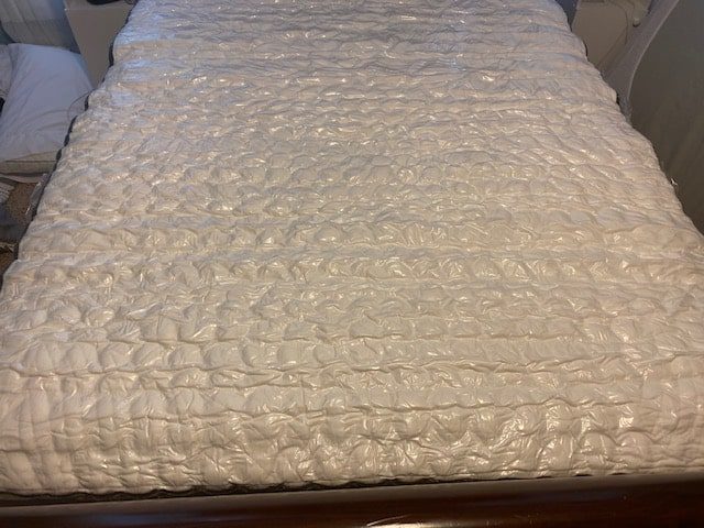 Unrolling it on the bed frame